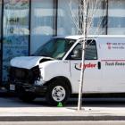 A van seized by police lies damaged after an incident where a van struck multiple people at a...