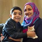 Former refugee Lama Tarawia and son Jawad Mattar (7) with their young kitten at their home in Kew...