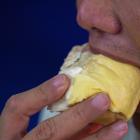 Thai man eating durian. Photo: Reuters