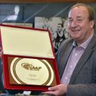 New Zealand Sports Hall of Fame chief executive Ron Palenski holds Peter Snell's IAAF Hall of...