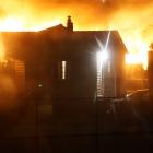 A view past houses in Dart St, Oamaru, of a fire in Regina Lane about 5am yesterday. Photo:...