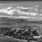 Something's missing in this wonderful old photograph of Dunedin, taken from the hill at St Clair...