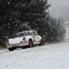 Allan Dippie, of Dunedin, powers his Porsche 911 into a corner as snow falls in Flagstaff...