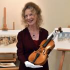 Dunedin illustrator Robyn Belton with the violin Dunedin soldier Alexander Aitken took to...