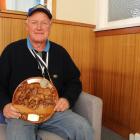 Alistair Rutherford, of Waimumu, displays his two new gold medals and trophy from the New Zealand...