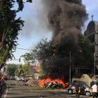 Motorcycles burn following a blast at the Pentecost Church Central Surabaya. Photo: Reuters