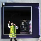 MCK Design and Print employee Wolfgang Gerber covers a window display at Cadbury World yesterday....