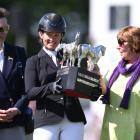 Jonelle Price poses with the trophy flanked by by HRH Princess Anne (L) and Classic Moet's co...