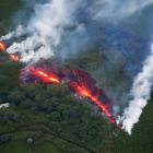 Lava erupts from a fissure east of the Leilani Estates subdivision during ongoing eruptions of...