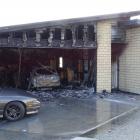 A car, garage and part of a residential property  were significantly damaged. Photo: Tracey Roxburgh