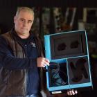 Malcam Trust youth worker Jethro Schreuder holds a box missing its virtual reality headset...