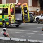Emergency services attend to a cyclist who was hit by a car yesterday morning. PHOTO: STEPHEN...