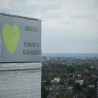  A sign with 'Grenfell Forever In Our Hearts' is displayed on the top of Grenfell Tower on June...
