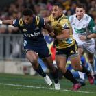 Waisake Naholo is tackled by Ben Lam during the match between the Highlanders and the Hurricanes at Forsyth Barr Stadium 01/06/18. Photo: Getty Images