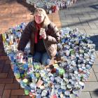 Presbyterian Support practice manager Deb Gelling with cans of food for Octacan in the Octagon on...