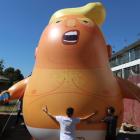 People inflate a helium filled Donald Trump blimp which they hope to deploy during The President...