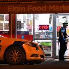 Police at the Elgin Food Market on Monday night. Photo: Stephen Jaquiery