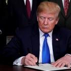 US President Donald Trump signs a memorandum on intellectual property tariffs on high-tech goods...