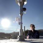 Otago Regional Council environmental scientist Deborah Mills surveys new air monitoring equipment...