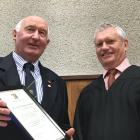 Long-serving Justice of the Peace Bill Townsend, of Alexandra, (left) is congratulated by Judge...