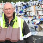 Waitaki Resource Recovery Trust manager Dave Clare holds a composite Roman roofing tile made in...