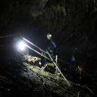Divers walk inside Tham Luang cave complex in the northern province of Chiang Rai. Photo: Reuters