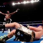 New Zealander Joseph Parker sprawls on the ground after being  knocked down by British boxer...