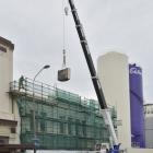 A section of parapet is removed from the former Cadbury Dairy building to make way for the...