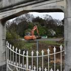 A contractor scrapes back the topsoil at the former site of the High Street School yesterday, so...