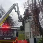 Firefighters tackle a fire in the smoke stack of a boiler at Kaikorai Valley College. Photo:...