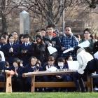 People gather in the Otago Museum reserve yesterday to commemorate the bombing of the Japanese...