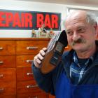 Cobbler Glenn’s owner Glenn Gray holds  the shoe phone he created for a Ben Rumble Communications...