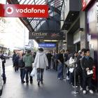 People queue on Auckland's Queen St waiting to be let into a Vodafone store to buy an iPhone 4....