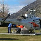 A Southern Lakes rescue helicopter unloads a man seriously injured in an avalanche at Lakes...