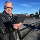 Rob Fitzpatrick inspects a chunk of asphalt left behind after a temporary repair of a bridge deck...