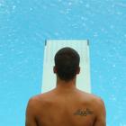 A Brazilian diver stands on a diving board as he prepares to dive during a practice session at...