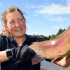 Dunedin City Council water treatment technician Caitlin Robertson holds one of the rainbow trout...