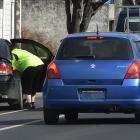 Police check car seats in North Dunedin this week. Photo: Gregor Richardson