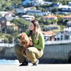 Department of Conservation ranger Jess Triscott keeps close tabs on Ralph the dog at St Clair...