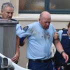 Sergeant Nathan White (centre) is supported by Constable Brent Mitchell and Aime Manning after...