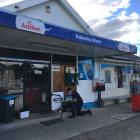 Constable Dean Paterson, of Oamaru, conducts a scene examination at the Kakanui Store following...
