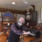 New Zealand Organ Museum Trust member Dr Ron Newton tickles the ivories of a mid-19th century...