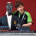 Charlie Mollard (15), of Palmerston North’s St Peter’s College, poses with his musical android....