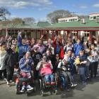 Sara Cohen School pupils, staff and friends show their approval after hearing the school is in...