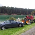 A rental car is towed from Purakaunui Inlet, near Dunedin, yesterday afternoon after it ended up...