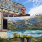  Central Otago Art Society president Nigel Wilson displays one of his artworks before the...