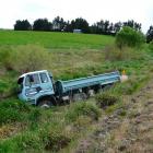 A gravel truck rests in swampy ground off the Owaka Highway near Finegand yesterday. It left the...