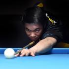 Dunedin 8-ball player Brendan Ng lines up the black during a practice session at Bowey’s Pool...