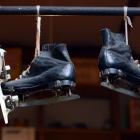 Ice skates hang from the ceiling.