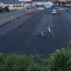 A worker paints lines on the freshly sealed Dunedin City Council car park in Thomas Burns St last...